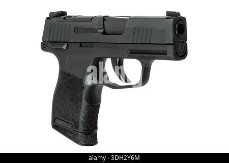 Black semi-automatic compact pistol with textured grip isolated on white. Stock Photo