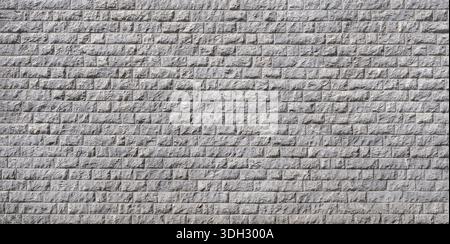 Cladding of a facade made of many rectangular gray stones Stock Photo