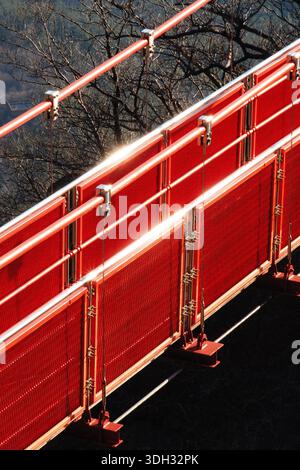 Red metal safety barrier on a cloud bridge at Wolchulsan Mountain, clean linear structure and bold color contrast creating a strong urban-style Stock Photo
