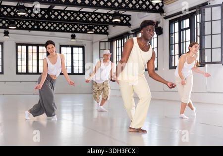 Four dancers exercising swing movements Stock Photo