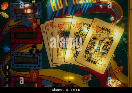 Close-up of playing card artwork and score displays on vintage pinball machine backglass. Stock Photo
