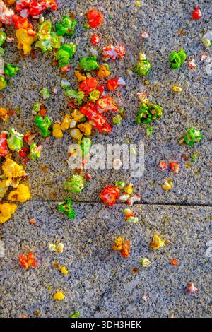 Scattered colorful popcorn on a textured stone surface Stock Photo