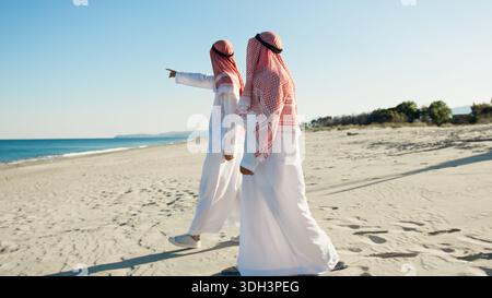Sheiks Walking To The Sea  Stock Photo