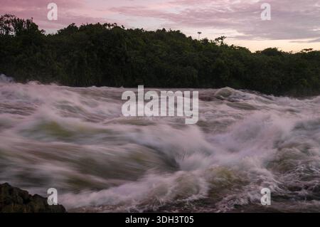 A close-up of the churning rapids of the River Nile in Jinja, Uganda, highlighting the powerful currents, frothy white water, and dynamic flow of Afri Stock Photo