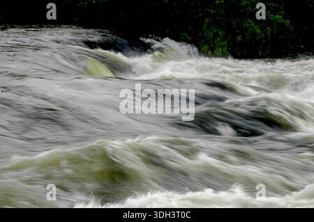 A close-up of the churning rapids of the River Nile in Jinja, Uganda, highlighting the powerful currents, frothy white water, and dynamic flow of Afri Stock Photo