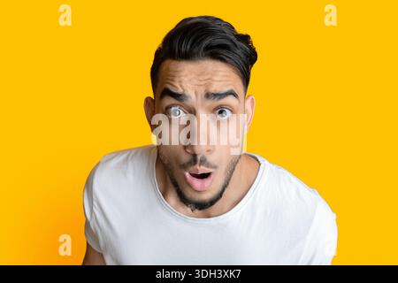 Closeup portrait of amazed arab man looking at camera Stock Photo