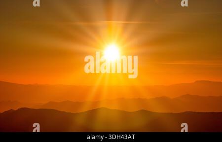 The sunset over mountain range and dramatic sky. Stock Photo