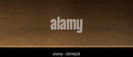 Elegant golden metallic table surface in perspective with fine grainy texture and soft depth of field. A premium luxurious backdrop perfect for produc Stock Photo