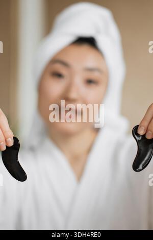 Woman Holding Gua Sha Tools Stock Photo