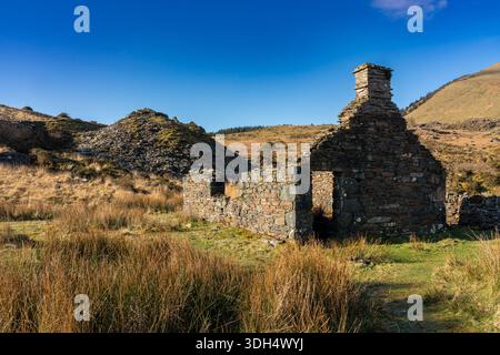Ruins of an old stone cottage with chimney on a hillside in Snowdonia Stock Photo