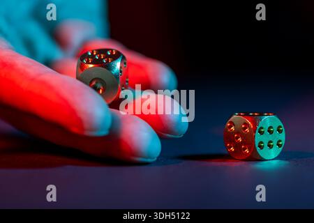 hand throws two dice on a black background, Stock Photo