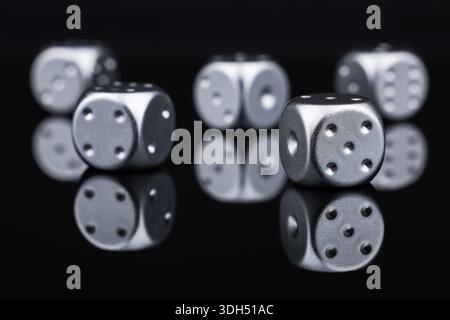 Five silver dice on black background. Stock Photo