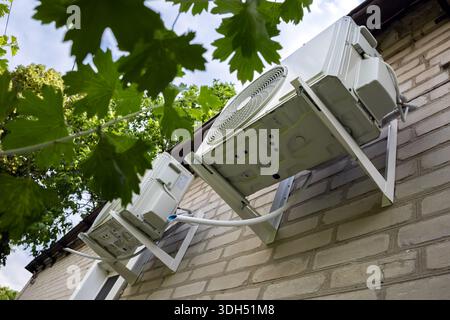 Outdoor two split air conditioning units mounted on siding wall. Stock Photo