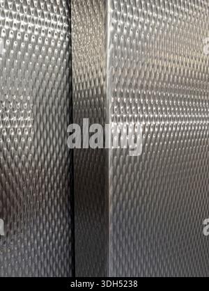 Detailed View Of Stainless Steel Surface Featuring Geometric Diamond Design And Subtle Light Reflection Stock Photo