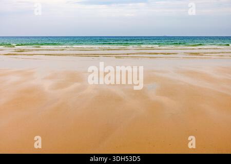 Sand beach with sea waves and a beautiful view to the horizon Stock Photo