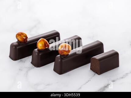 Delicious Chocolate Bars with Hazelnuts on Marble Background Stock Photo