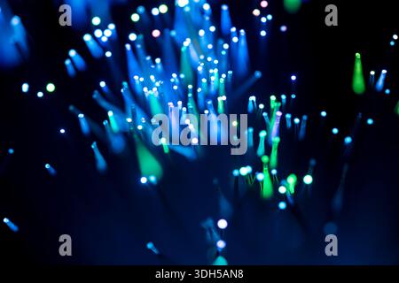 Captivating abstract image of blue and green fiber optic lights glowing against a deep black background, creating a vibrant and futuristic visual effe Stock Photo