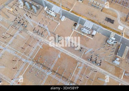 Aerial view of a modern power station showcasing electrical infrastructure with transformers, power lines, and control buildings, illustrating advance Stock Photo