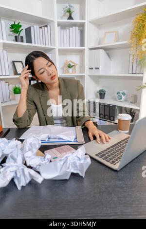 Stressed businesswoman dealing with heavy work pressure, reacting emotionally while reviewing reports and facing tight deadlines, highlighting workpla Stock Photo