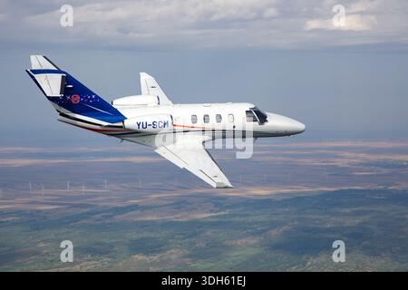 The image shows a Serbian Air Force Cessna 525 CitationJet M2, registration YU-SCM, Serial No. 525-0918, with a close-up pilot view in an air-to-air configuration. The Citation M2 is a light business jet powered by two Williams FJ44-1AP turbofan engines, featuring a low-wing design, T-tail, pressurized cabin, and advanced avionics. It is used for executive transport, training, and light utility missions in the Serbian Air Force. Stock Photo