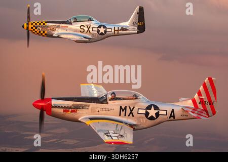 Two North American P-51 Mustang aircraft flying air to air at the Sun N Fun Aerospace Expo Florida 2025 including Cavalier ETF-51D Mustang 2 registration N51MX named Mad Max and North American P-51D Mustang registration N51LW named Little Witch shown in United States Air Force display paint with close up pilot view both aircraft powered by Packard built Rolls Royce Merlin V-1650 liquid cooled V12 piston engines featuring bubble canopies laminar flow wings and four blade propellers operating together in daylight formation flight conditions Stock Photo