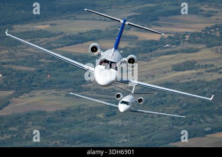 Cessna 525 CitationJet M2 (YU-SCM, 525-0918) and Cessna 560XL Citation XLS (YU-SVL, 560-5772), operated by Prince Aviation, are seen flying in formation during air-to-air operations at Serbian Airpower 2025. The M2 features twin Williams FJ44-1AP-21 engines, 404 knots cruise, 41,000 feet ceiling, and 1,550 nm range. The XLS has twin Williams FJ44-3A engines, 441 knots cruise, 45,000 feet ceiling, and 2,100 nm range. Both aircraft have pressurized cabins and advanced avionics. Stock Photo