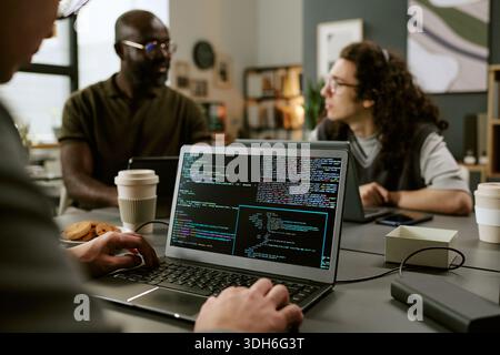 Young Adult Multiethnic Coworkers Collaborating on Software Development Project Stock Photo