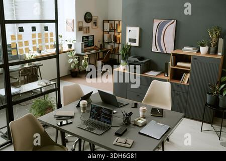 Modern Office Workspace Featuring Laptops and Smartphones on Table Stock Photo