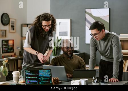 Multiethnic Young Adults Collaborating on Software Development Project Stock Photo