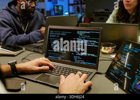Young Adult Men Collaborating on Software Development Project Stock Photo