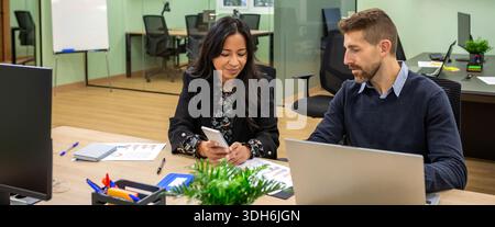 Banner of diverse business professionals using technologies while collaborating in coworking office Stock Photo
