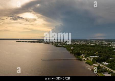 Hurricane season in Florida. Thunderstorm rolling across Charlotte Harbor. Dark stormy clouds and heavy rainfall over coastal suburbs. Stock Photo