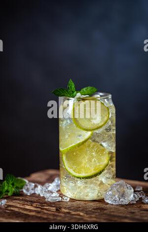 Summer drink green Iced tea with lemon slices and mint on dark background Stock Photo