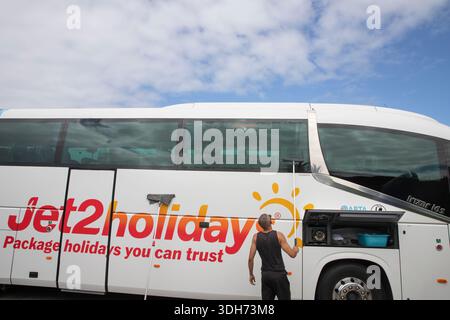 Worker cleaning Jet2holidays tour bus during routine maintenance in Tenerife Spain September 15 2024 Stock Photo