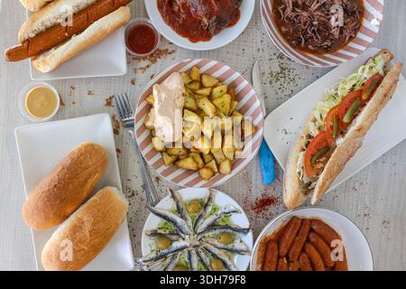 Assortment of spanish tapas, hot dogs, and sandwiches ready for a meal Stock Photo