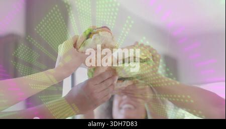 Raising four short-sleeved friends holding burgers to center in lit room, with green-purple overlay Stock Photo