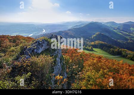 View from the Gisliflue of an autumn-colored forest, behind the Jurassic foothills with water fluh and stripes in the light of the setting sun, Talhei Stock Photo
