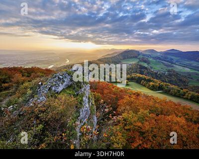 View from the Gisliflue of an autumn-colored forest, behind the Jurassic foothills with water fluh and stripes in the light of the setting sun, Talhei Stock Photo