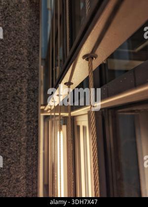 Nighttime Urban Setting Featuring Luminous Reflections On Contemporary Metal And Bronze Exteriors Stock Photo