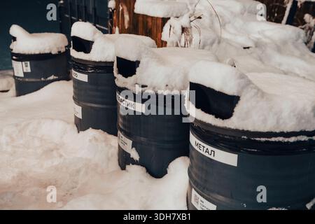 Modern waste management bins for sorting garbage in a city park at night. The close-up shot captures the colorful surfaces of the containers against t Stock Photo