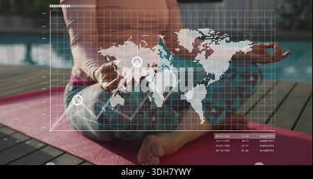 Sitting woman in peach top meditating on pink mat on pool deck, showing digital map overlay Stock Photo