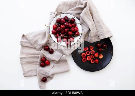 flat lay of dishes with cherries on a white background Stock Photo