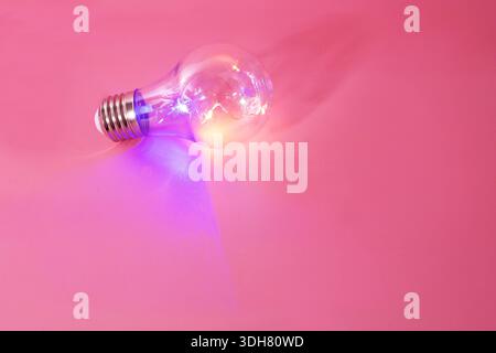 color light bulb on pink background Stock Photo