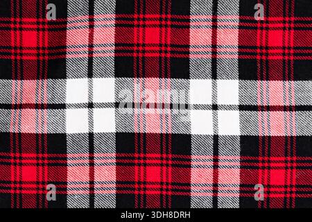 background in a cage white with red and black fabric close-up. Stock Photo