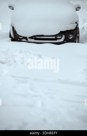 Parked car covered in snow after heavy snowfall Stock Photo