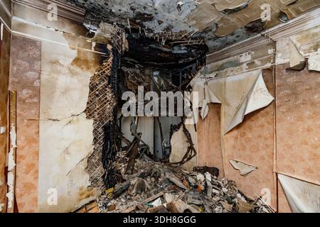 Aftermath of explosion and fire after attack. Burnt domestic room interior. Stock Photo