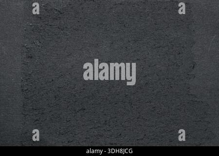 Black rough paper close-up, monochrome dark background for design, printing, presentations Stock Photo