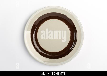 Empty restaurant dinner plate shot from above, isolated on white background. Brown white ceramic plate Stock Photo