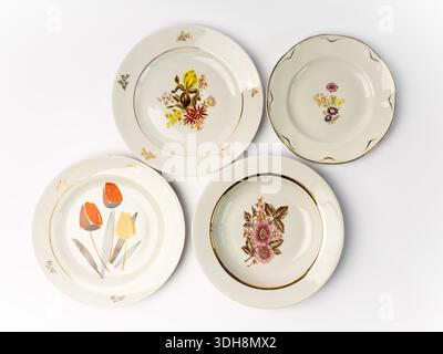 Empty vintage white plate with flowers, isolated on white background. Looking down plates. Food photography props Stock Photo