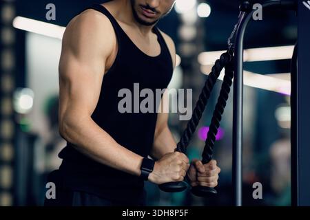 Bodybuilding Concept. Young Muscular Man Working Out Biceps On Fitness Machine Stock Photo